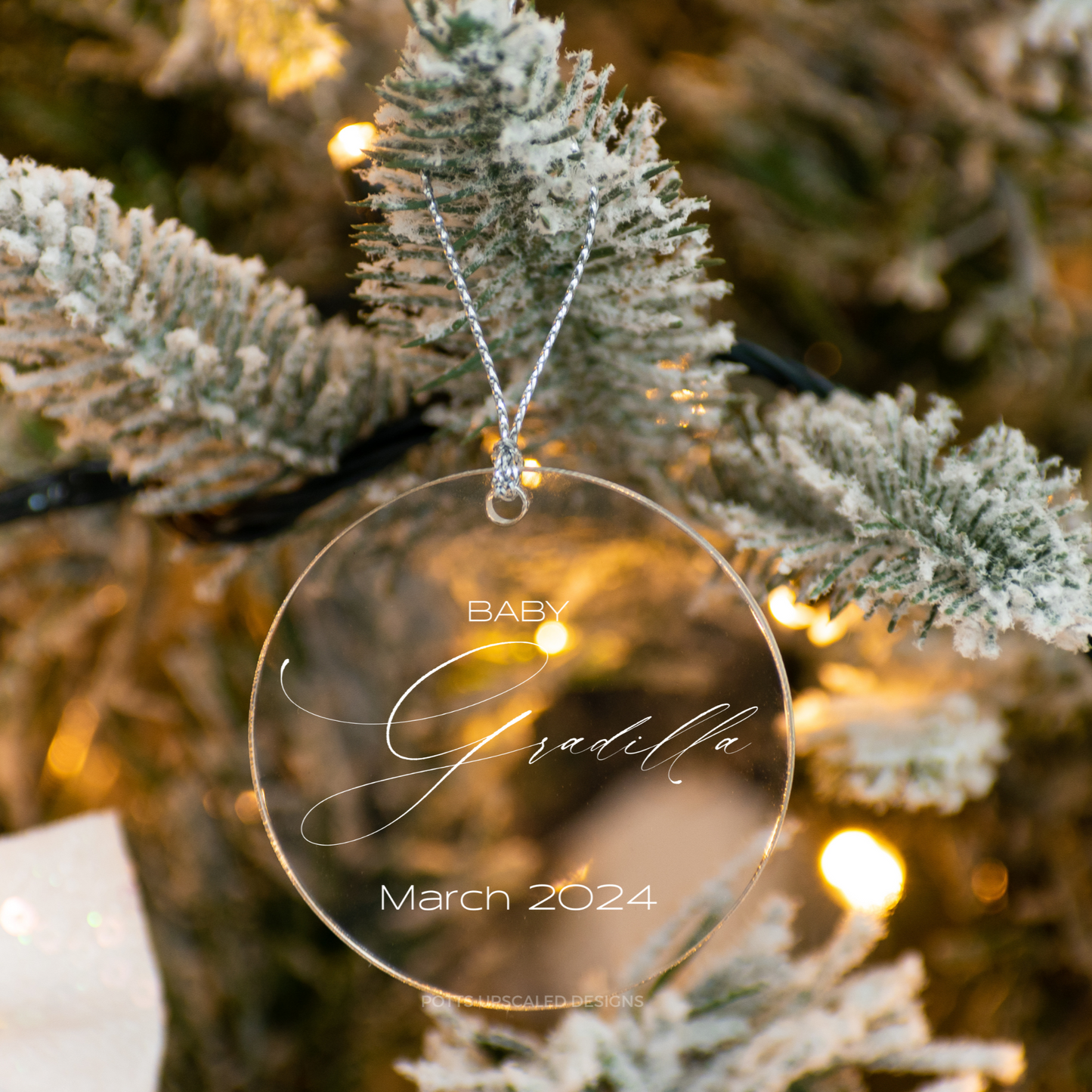 Baby announcement ornament in clear acrylic engraved with the baby name and expecting month made by Potts Upscaled Designs LLC