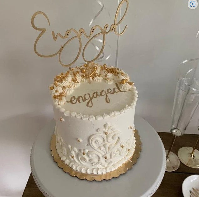 Gold Engaged Cake Topper on White Cake For Engagement Party Decor