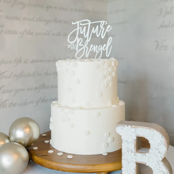 Potts Upscaled Designs LLC Personalized Future Mrs Cake Topper in white acrylic for a bridal shower cake in white with champagne balloons