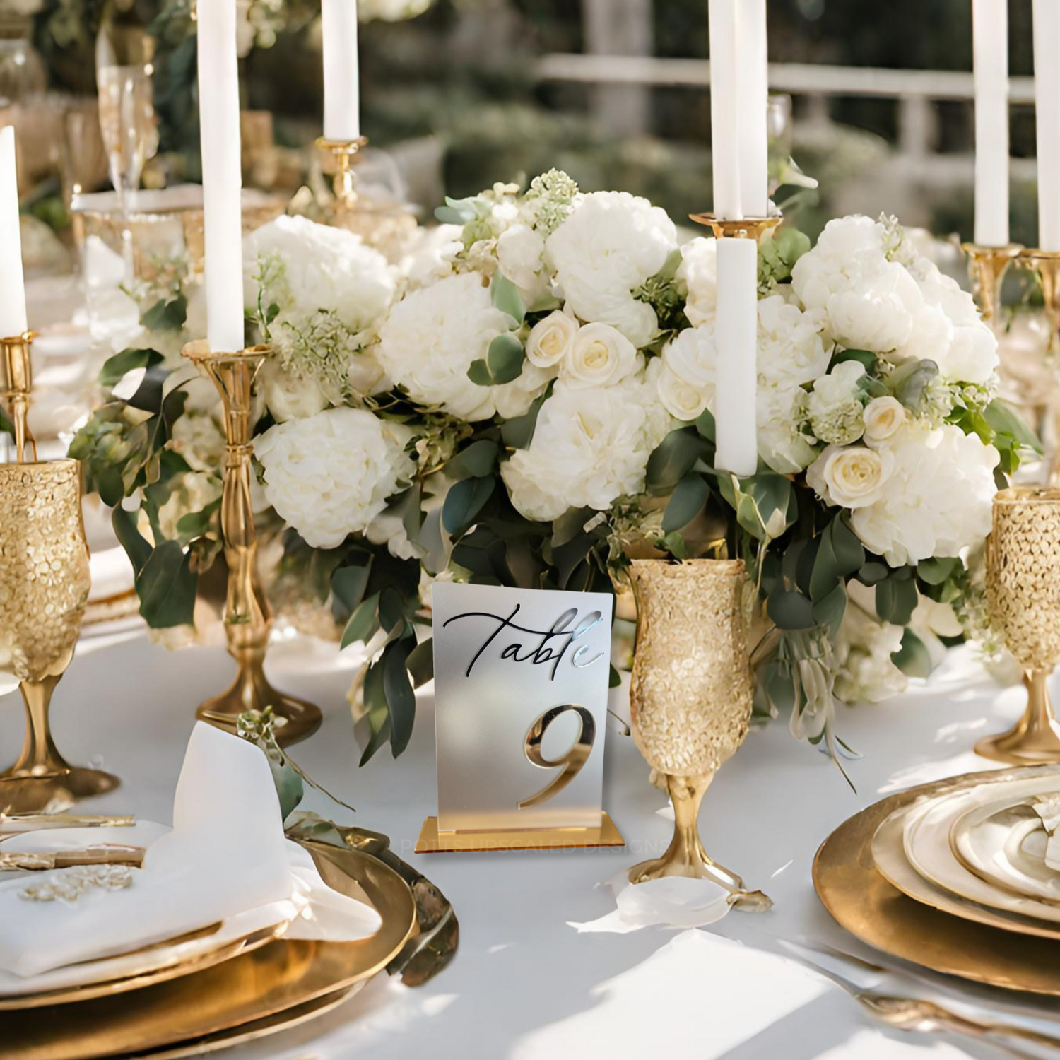 gold mirror table numbers for wedding on a white table white flowers and gold plates