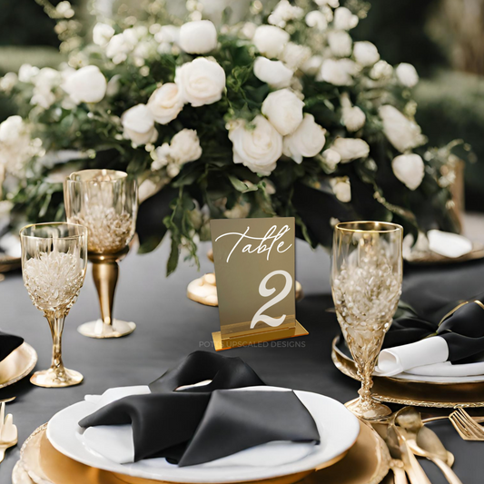 gold mirror table number with 3d white acyrlic lettering on top for assigned seating at a wedding
