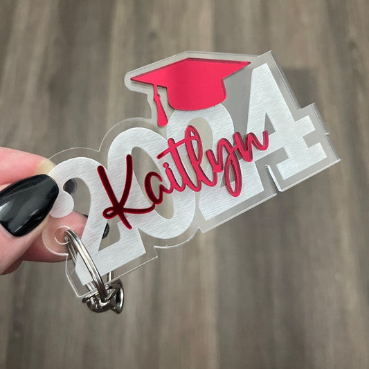 Graduation key chain bag tag personalized name and school colors on a keyring and lobster claw clip and tassel charm