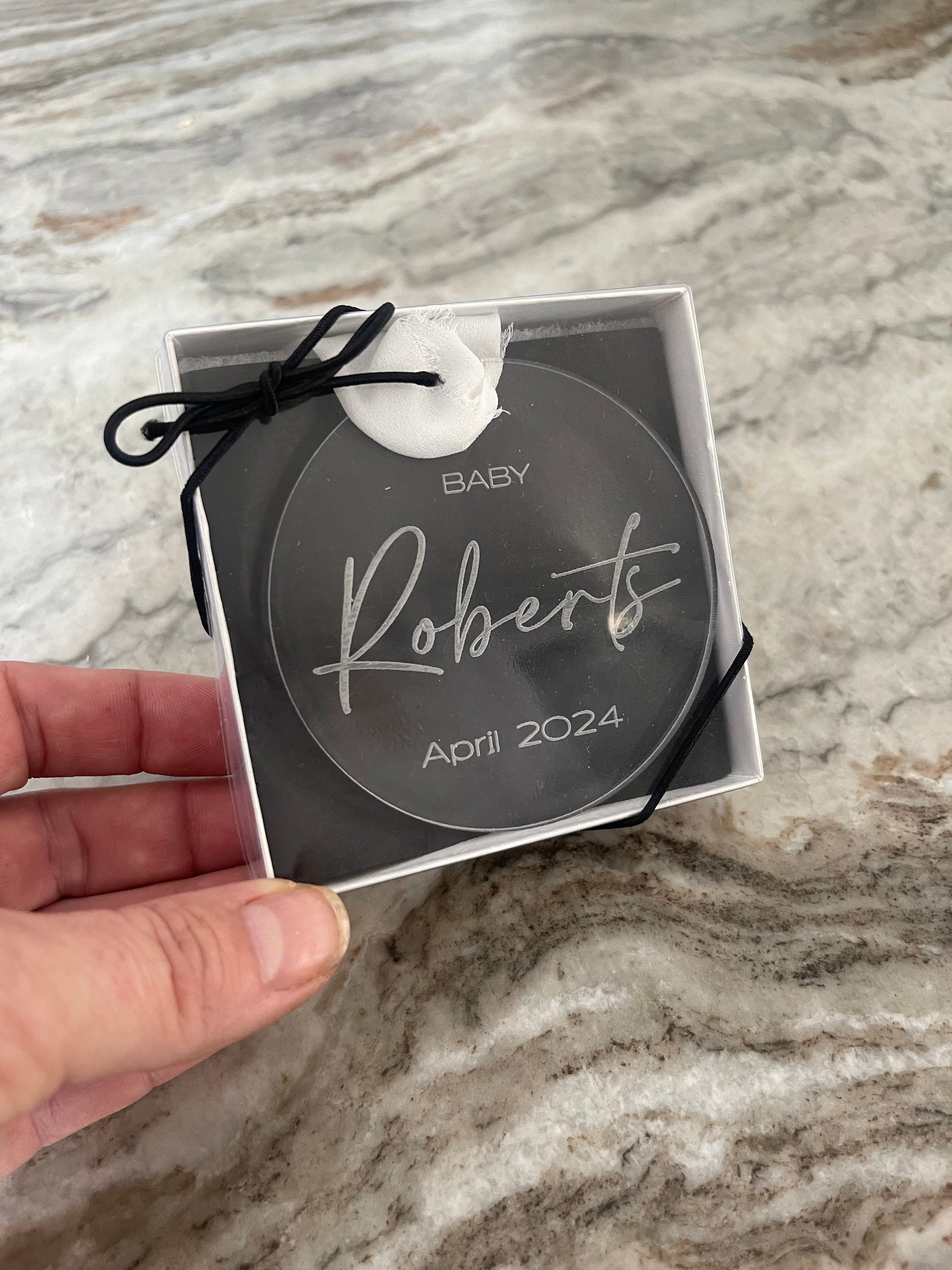 Gift box with clear lid and black bow for clear acrylic christmas ornament for baby announcement