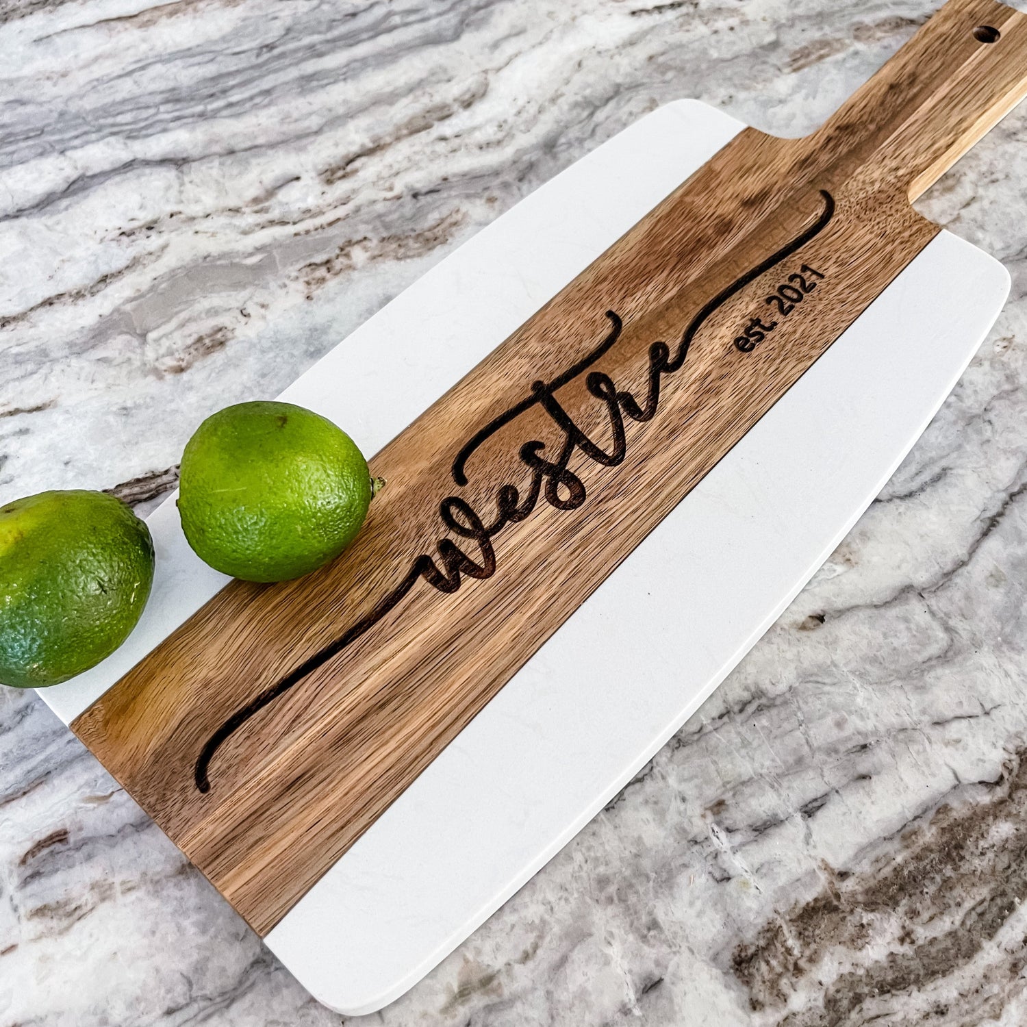White marble and acacia wood charcuterie board serving tray with handle engraved with last name and est date by Potts Upscaled Designs LLC