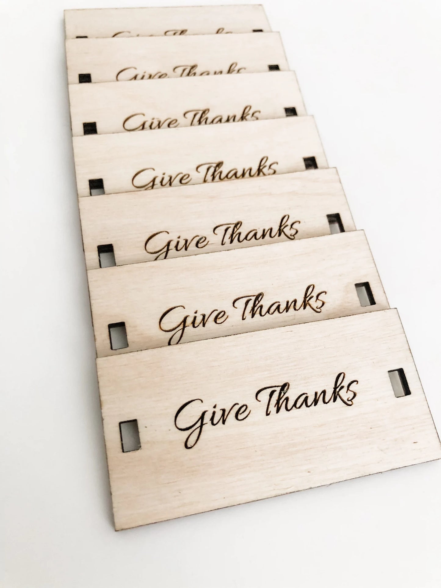 Set of wooden napkin tags with 'Give Thanks' text on a white background for fall thanksgiving