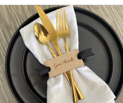 Wood Give Thanks Napkin Tags tied with black ribbon on black plates with off white cloth napkins for thanksgiving table decor
